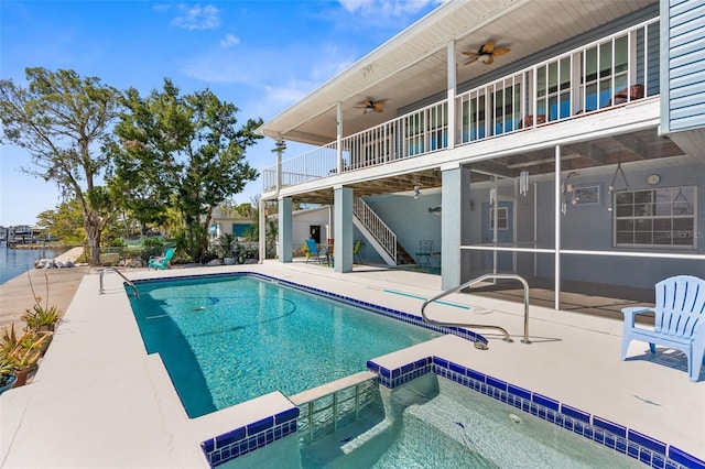 view of pool with stairway, a patio area, a pool with connected hot tub, and a ceiling fan