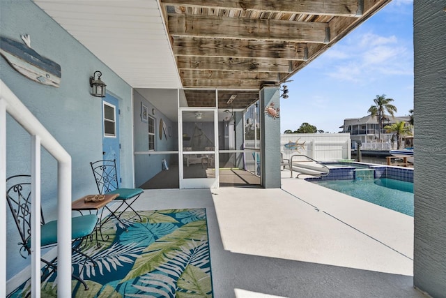 view of patio featuring a pool with connected hot tub