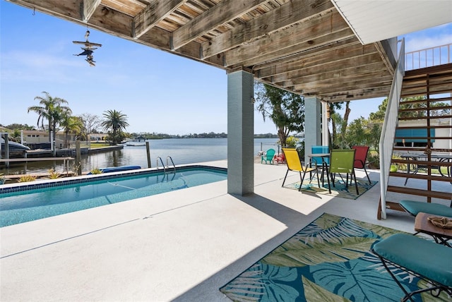 pool with a water view, stairs, and a patio