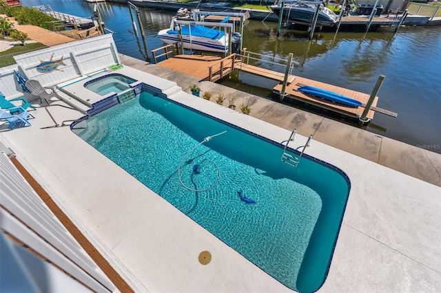 view of swimming pool with a patio, a boat dock, boat lift, a water view, and a pool with connected hot tub