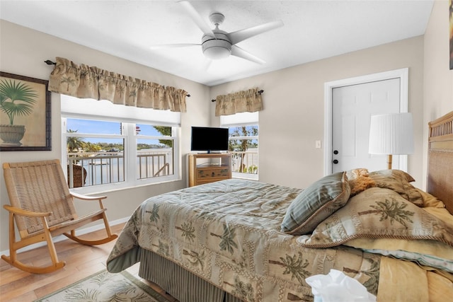 bedroom with ceiling fan, baseboards, and wood finished floors