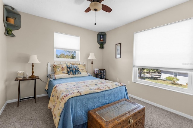 bedroom with multiple windows, carpet, a ceiling fan, and baseboards