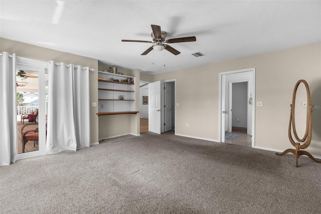 interior space with baseboards, visible vents, ceiling fan, a textured ceiling, and carpet flooring