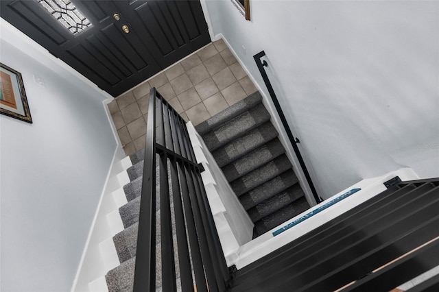 staircase featuring tile patterned floors