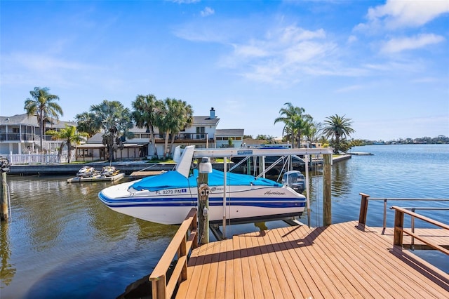 dock area with a water view and boat lift