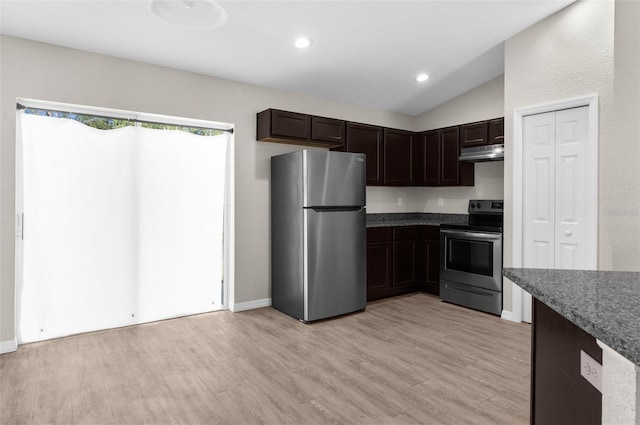 kitchen with under cabinet range hood, vaulted ceiling, dark brown cabinets, appliances with stainless steel finishes, and light wood-type flooring