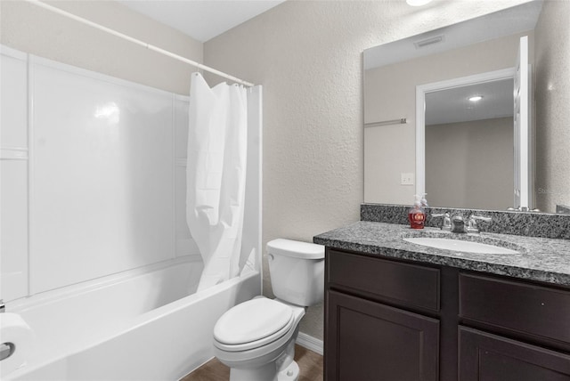full bathroom with shower / bath combo, a textured wall, vanity, and toilet