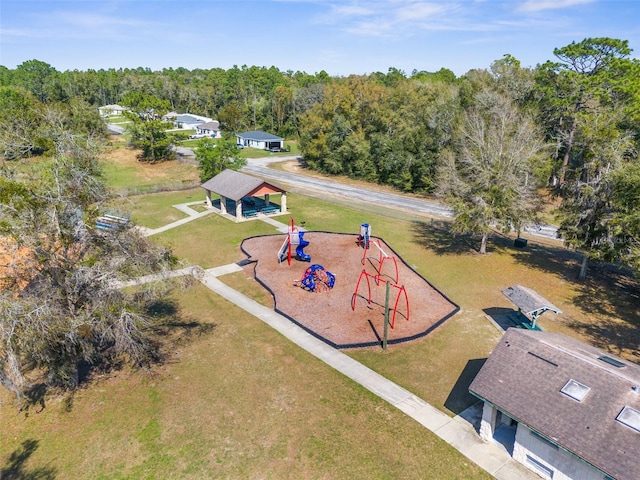birds eye view of property featuring a view of trees