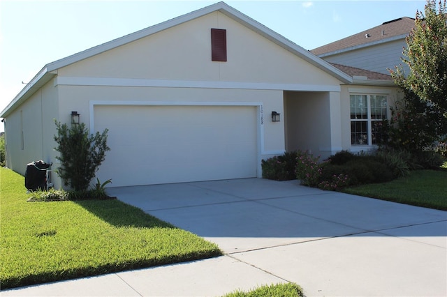 ranch-style home with a garage, concrete driveway, a front lawn, and stucco siding