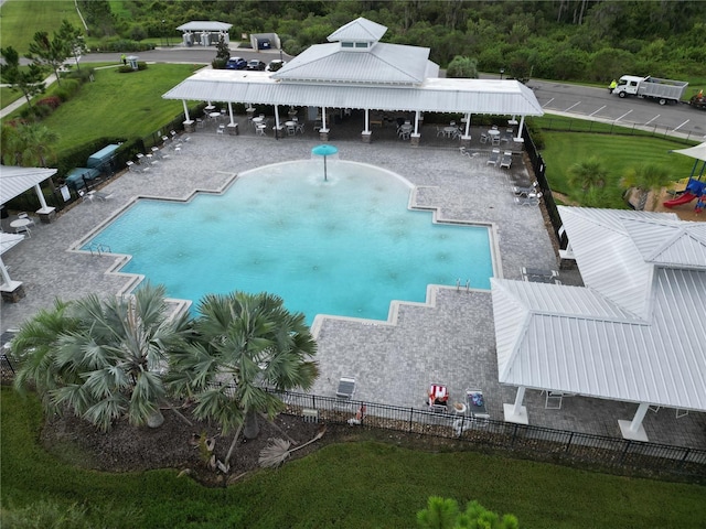 community pool with fence, a patio, a gazebo, and a lawn