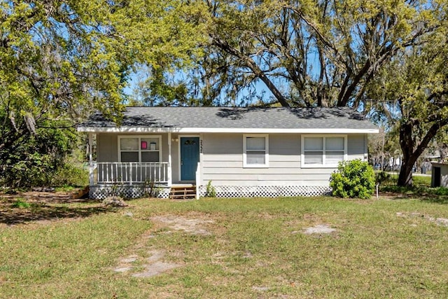 view of front of house with covered porch and a front lawn