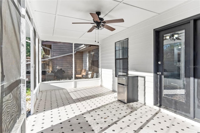 sunroom / solarium featuring ceiling fan