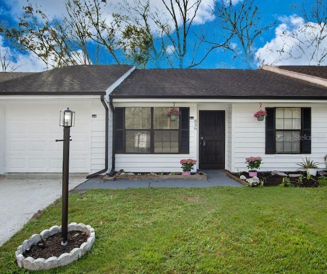 ranch-style home featuring a shingled roof, a front yard, and an attached garage