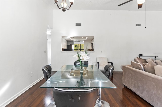 dining space featuring baseboards, visible vents, wood finished floors, and ceiling fan with notable chandelier