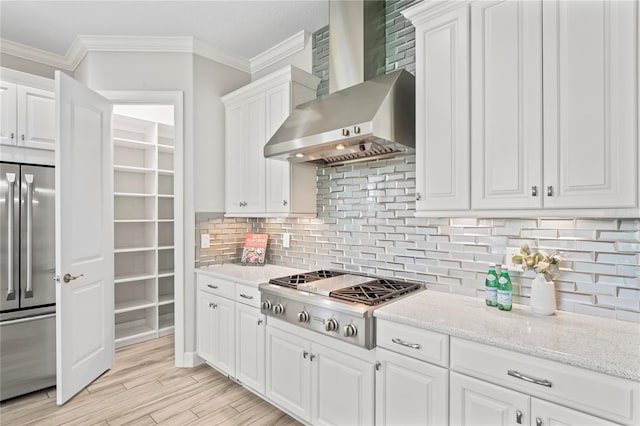 3130 Forsythia Dr, Odessa, FL 33556 - kitchen featuring stainless steel appliances, wall chimney exhaust hood, crown molding, white cabinets, and backsplash