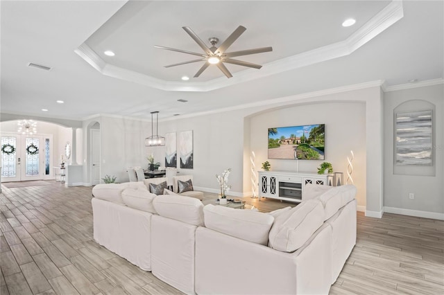 3130 Forsythia Dr, Odessa, FL 33556 - living room with a chandelier, a raised ceiling, light wood-type flooring, recessed lighting, and baseboards