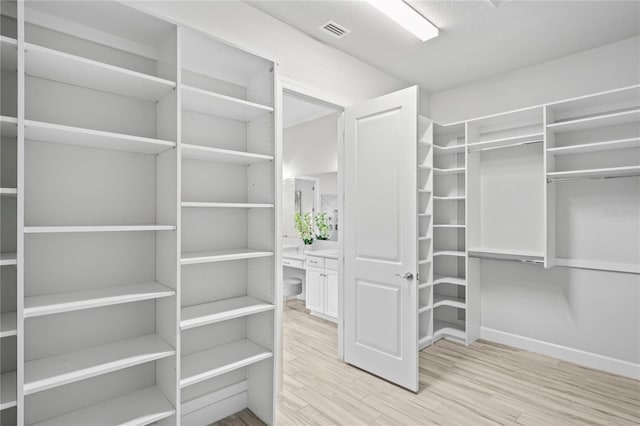 3130 Forsythia Dr, Odessa, FL 33556 - walk in closet with wood finished floors