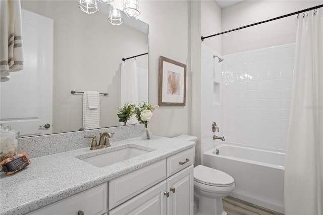 3130 Forsythia Dr, Odessa, FL 33556 - full bath featuring vanity, toilet, shower / bath combination with curtain, and wood finished floors