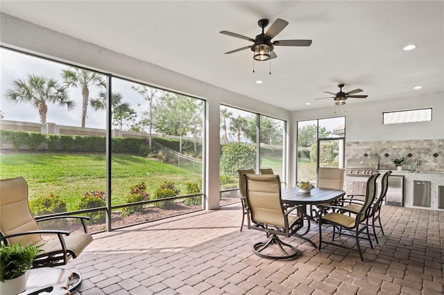 3130 Forsythia Dr, Odessa, FL 33556 - sunroom / solarium with exterior kitchen, a ceiling fan, and outdoor dining area