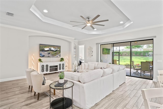 3130 Forsythia Dr, Odessa, FL 33556 - living room featuring a raised ceiling, ceiling fan, light wood-style flooring, crown molding, and recessed lighting