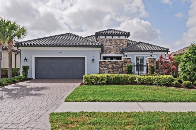 3130 Forsythia Dr, Odessa, FL 33556 - mediterranean / spanish-style house featuring stucco siding, stone siding, decorative driveway, and an attached garage