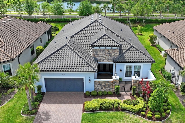 3130 Forsythia Dr, Odessa, FL 33556 - view of front of home with an attached garage, a tiled roof, stucco siding, driveway, and stone siding