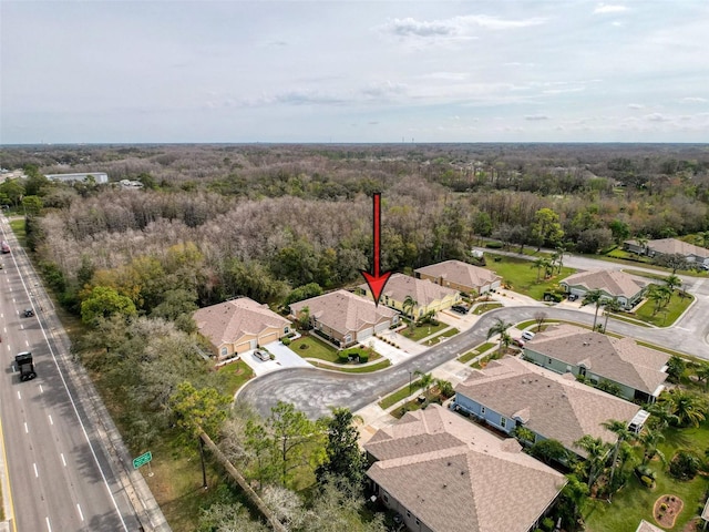 bird's eye view with a residential view and a wooded view