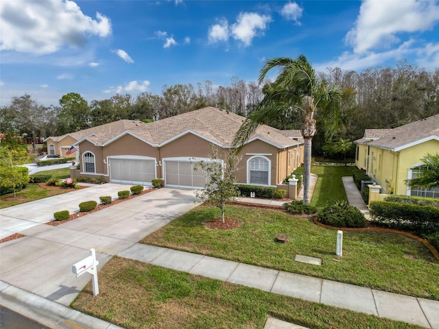 single story home with a garage, driveway, a front yard, and stucco siding