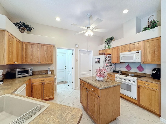 kitchen featuring white appliances, a toaster, light tile patterned floors, and a center island