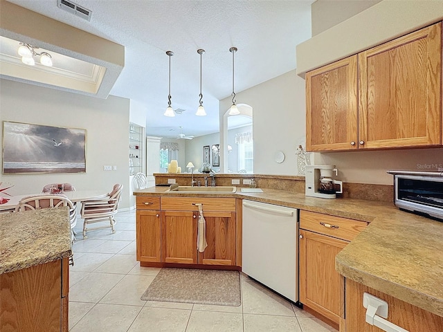 kitchen with light tile patterned floors, visible vents, white dishwasher, a sink, and a peninsula