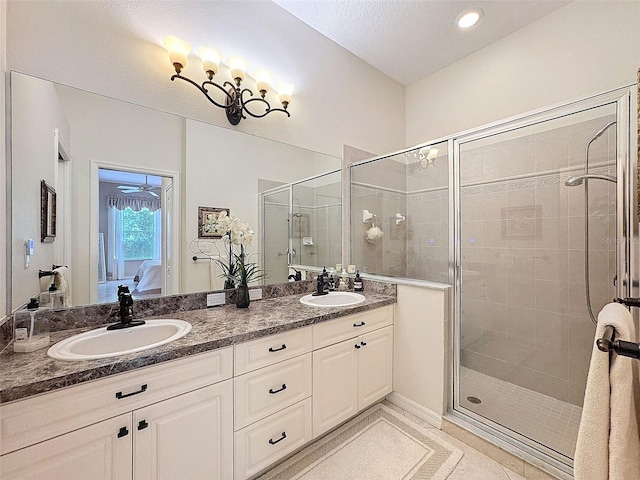 full bath with connected bathroom, a sink, and a shower stall