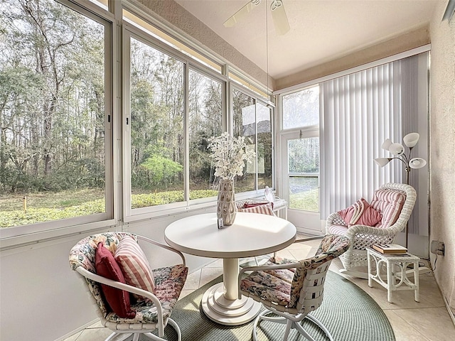 sunroom / solarium with a ceiling fan