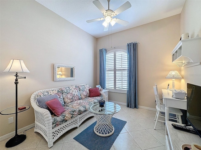 tiled living room featuring ceiling fan and baseboards