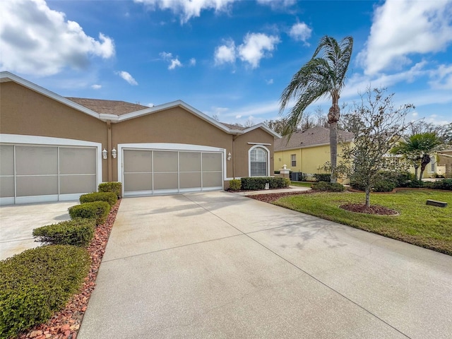 single story home featuring a garage, concrete driveway, a front lawn, and stucco siding