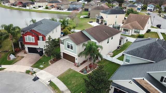 drone / aerial view featuring a water view and a residential view