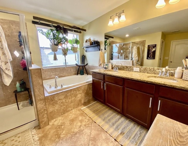 bathroom featuring a stall shower, double vanity, a sink, and a bath