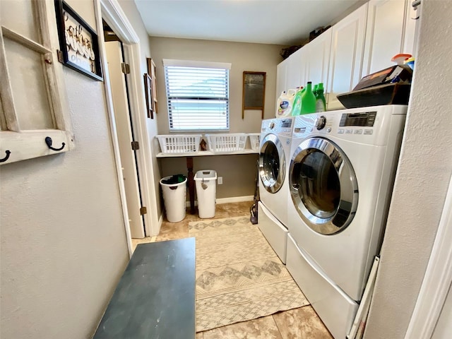 washroom featuring washing machine and clothes dryer and cabinet space