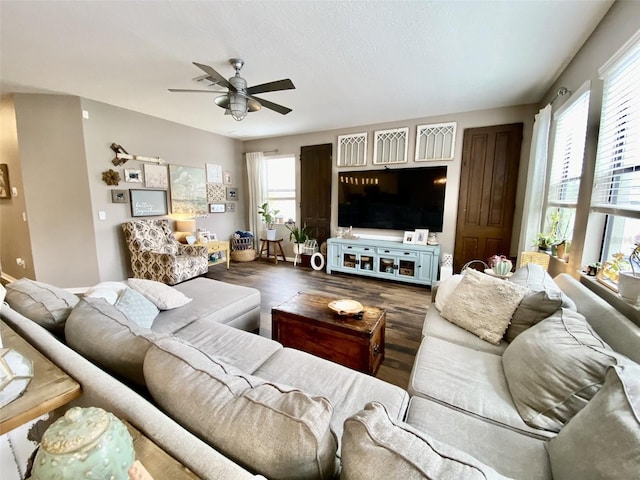 living room with ceiling fan and wood finished floors