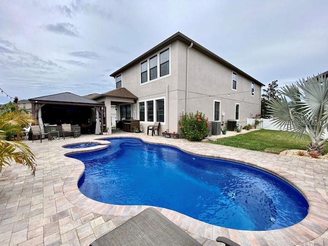 outdoor pool featuring a gazebo, an outdoor hangout area, a patio area, fence, and central AC