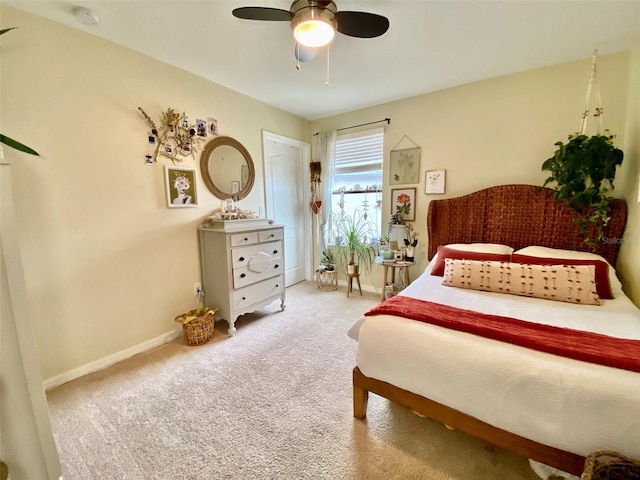 bedroom with ceiling fan, carpet floors, and baseboards