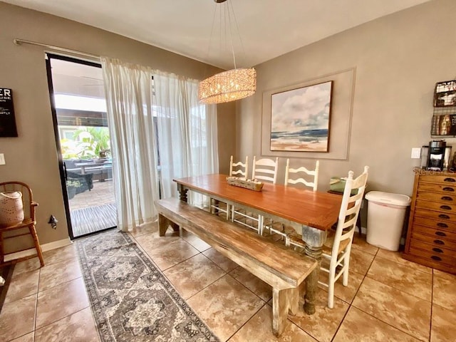 dining room with light tile patterned flooring and baseboards