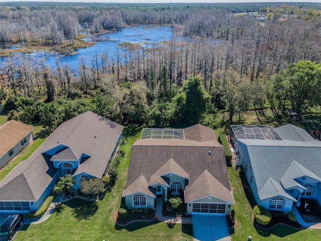 drone / aerial view with a water view and a view of trees