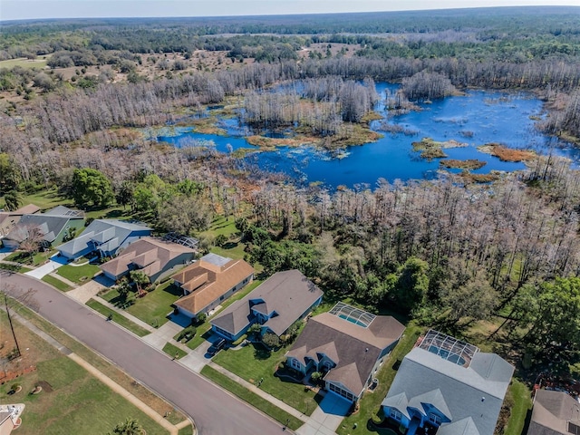 aerial view with a residential view, a water view, and a forest view