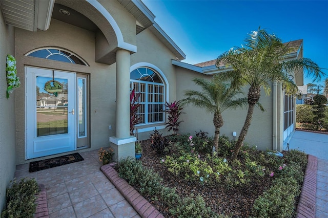 doorway to property with stucco siding