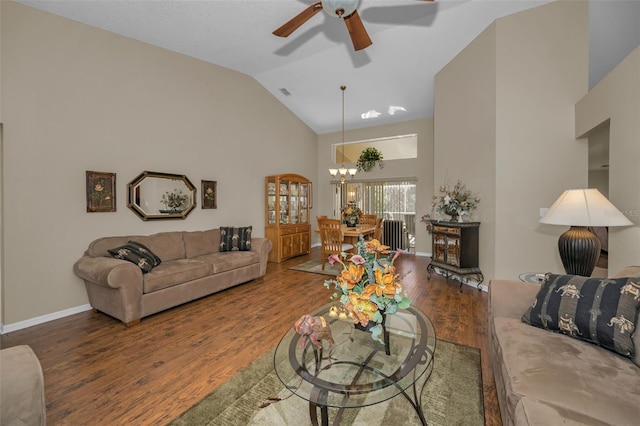 living room featuring high vaulted ceiling, ceiling fan with notable chandelier, baseboards, and wood finished floors