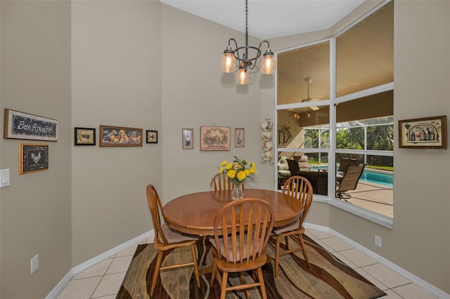 dining area with a chandelier, a sunroom, baseboards, and light tile patterned floors