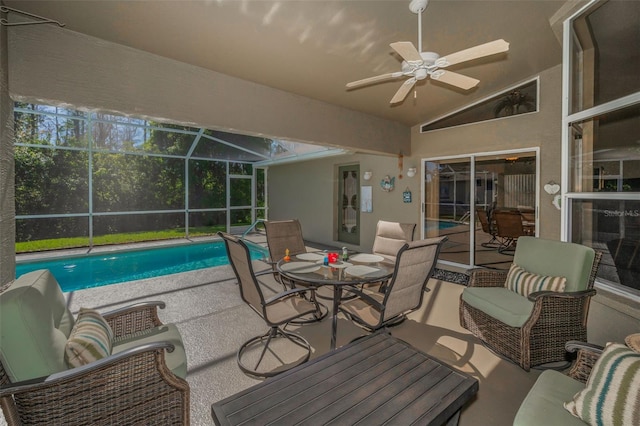 exterior space with outdoor dining area, a patio, outdoor lounge area, a ceiling fan, and a lanai