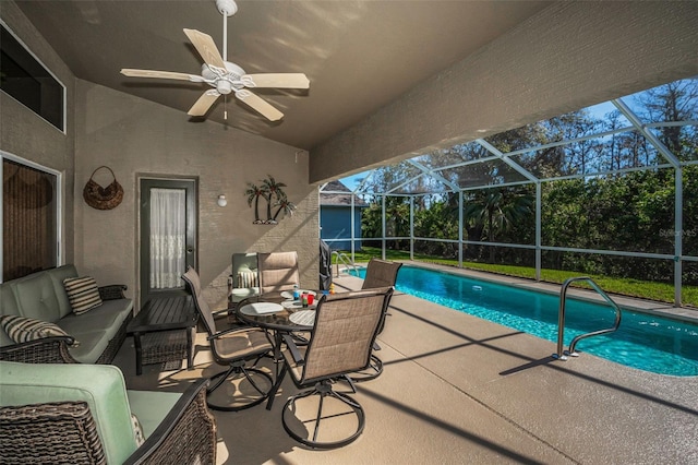 pool with ceiling fan, glass enclosure, outdoor lounge area, and a patio area