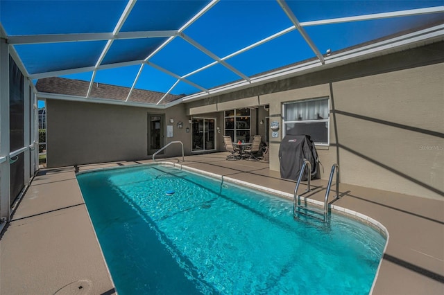 outdoor pool with a patio, grilling area, and a lanai