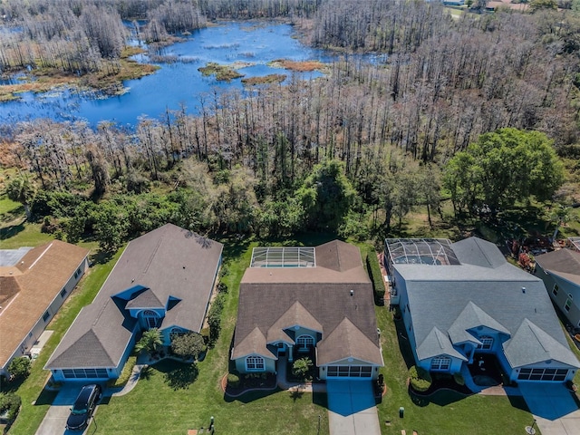 bird's eye view with a water view and a forest view